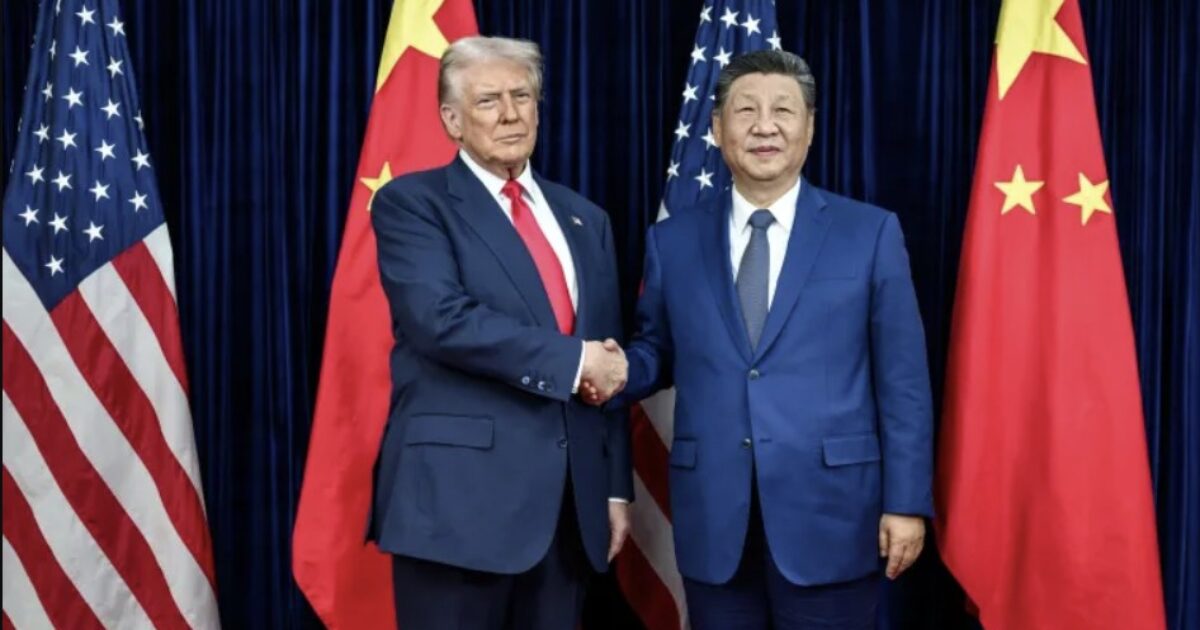 Donald Trump and Xi Jinping shake hands during a diplomatic meeting, with American and Chinese flags in the background, symbolizing U.S.-China relations.